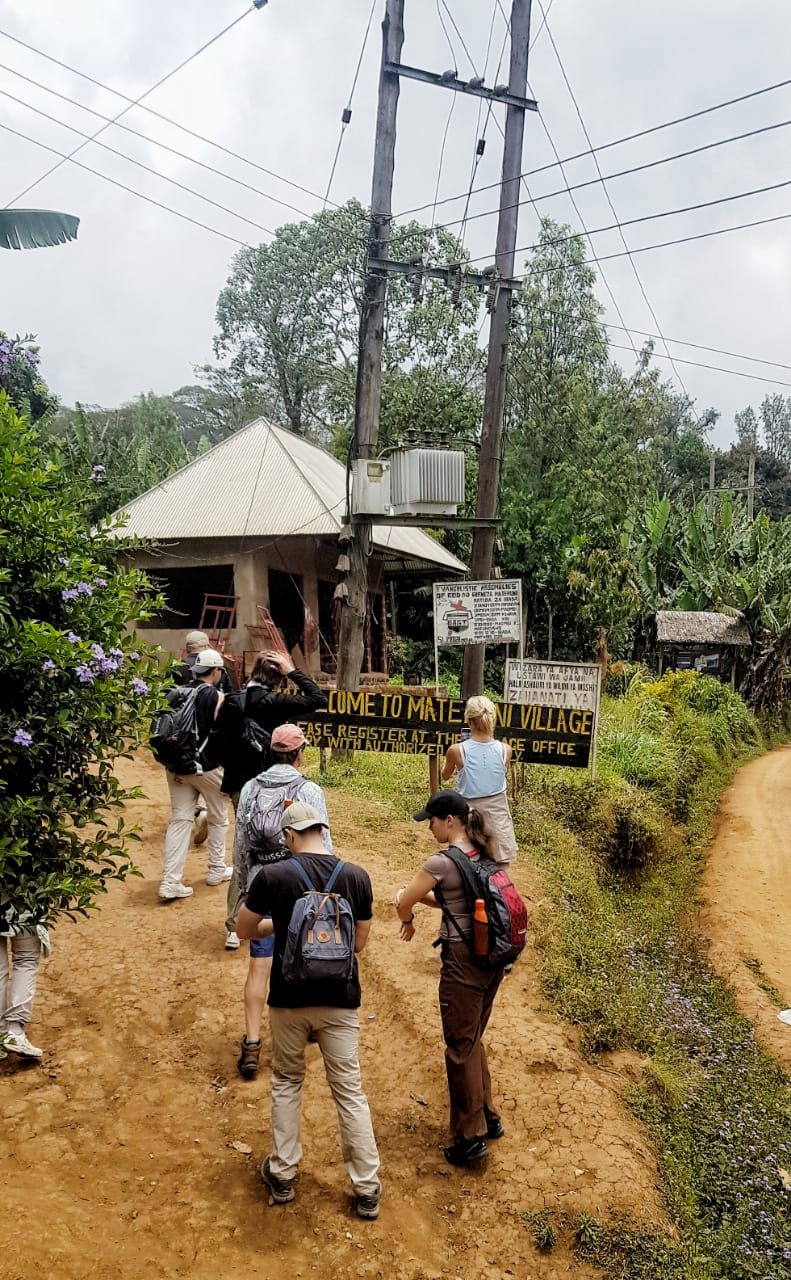 A group walking into Materuni village
