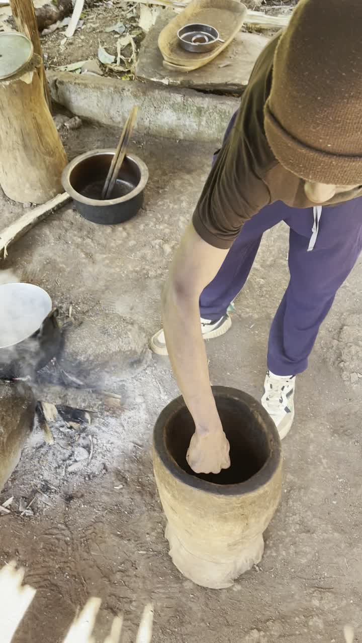 Roasted coffee pounded by hand in a wooden mortar
